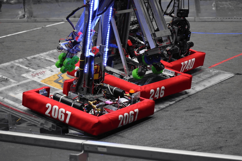 The Lobstah Bots driving up the charge station to balance with teammates at the end of a qualification match.