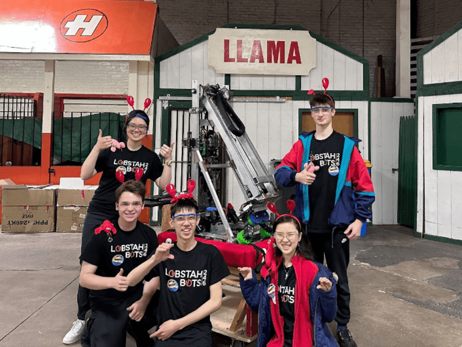 Veronica (Mentor), George '24, Maxwell '25, Kendree '25, and Owen '25 posed for a photo with our robot by the Llama sign. Our robot this year was named “Llama," so this photo was rather fitting.