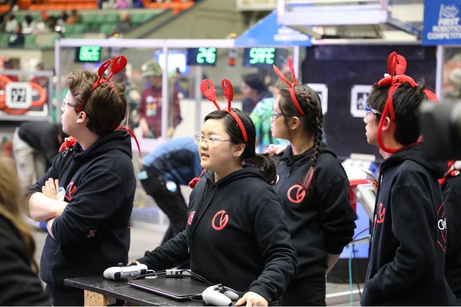 Our drive team – George Baltus '24, Kendree Chen '25, Veronica Hui (mentor), Maxwell Yu '25, and Sharon Xiong '27 (not pictured) – bringing the robot onto the field.