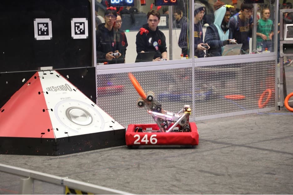 Maxwell Yu '25 and George Baltus '24 shooting a note into the speaker during a match.