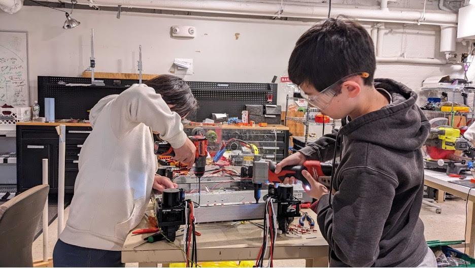 Kendree '25 and Sebastian '27 riveting the bottom plates onto the drivetrain of our offseason robot.