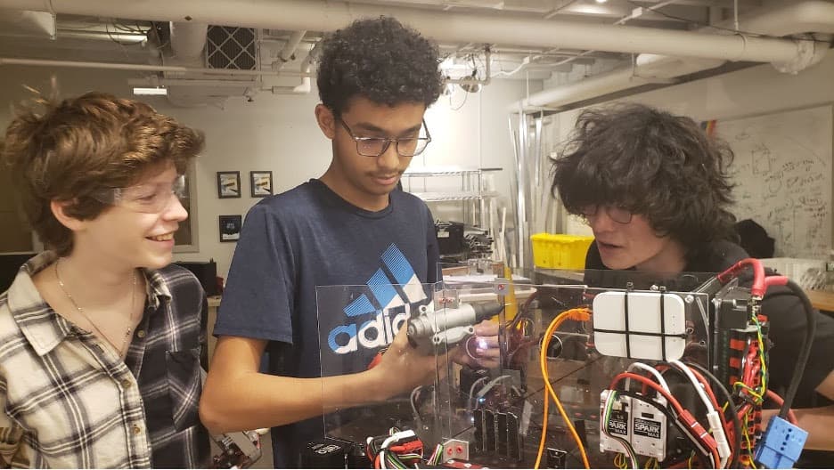 Coco '26, Yaseen '24, and Luke '25 working to rivet the hopper to our offseason robot.