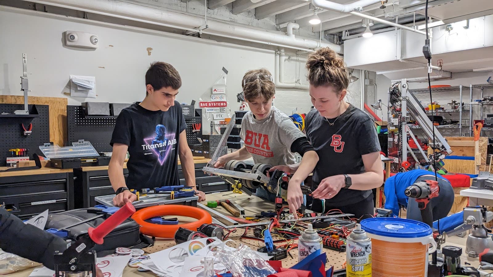 Daniel David '27 and Coco Mueller '26 working together with mentor Madison to test our shooter prototype.