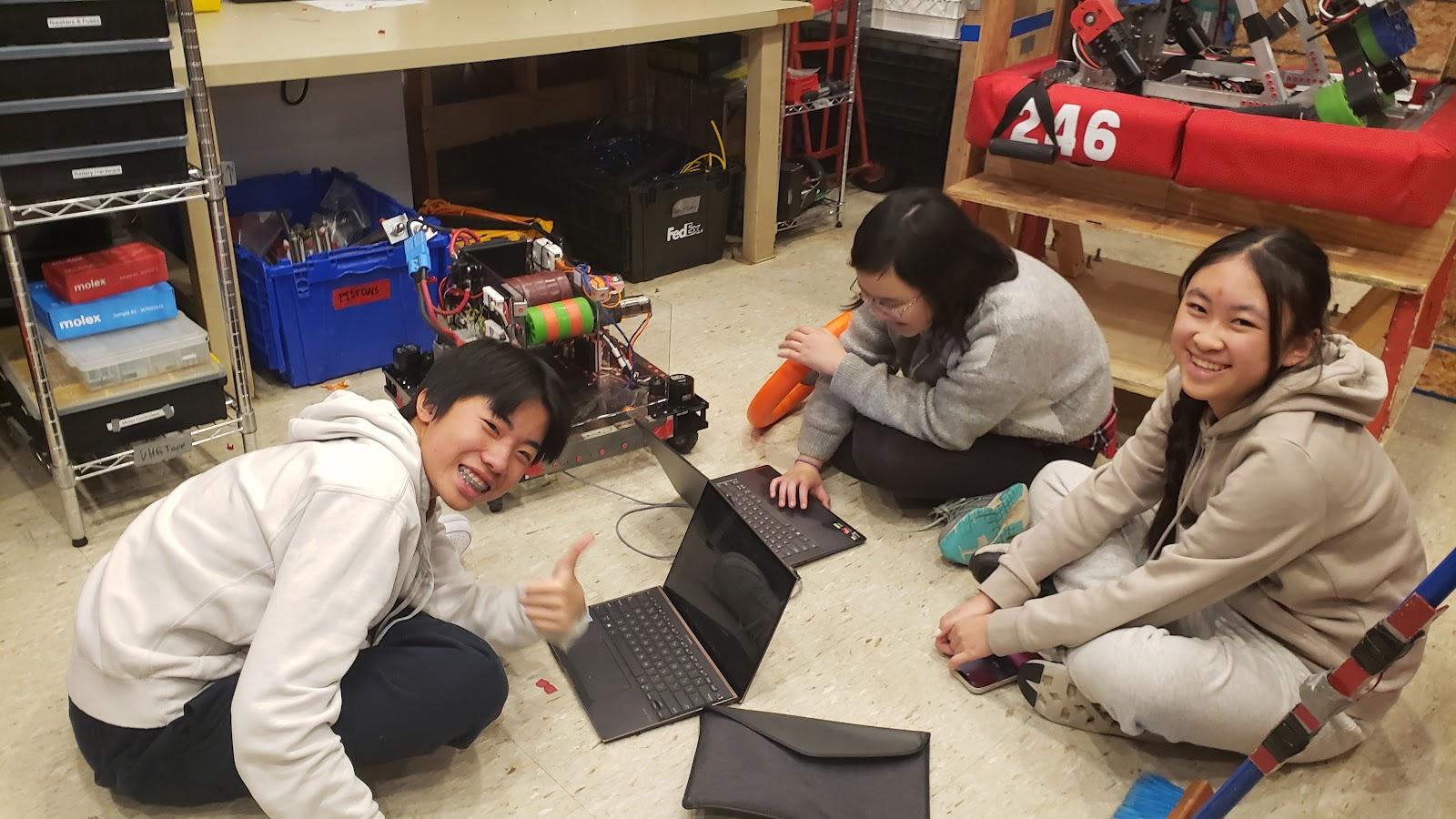 Teddy Shi ‘27,  Kendree Chen ‘25, and Sharon Xiong ‘27 collaborating on code for our swerve modules.