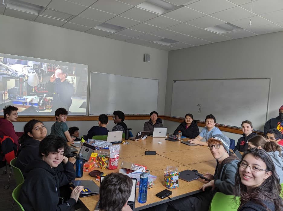 The team watching the 2023 FIRST® Charged Up kickoff video.