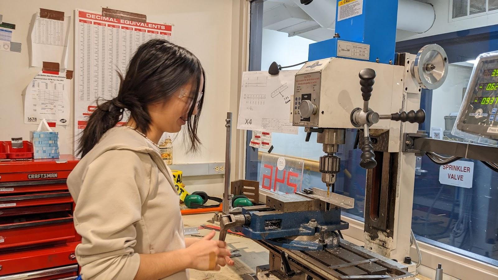 Coco Shen ‘27 drilling holes into one of our bumper brackets at our lab’s milling machine.