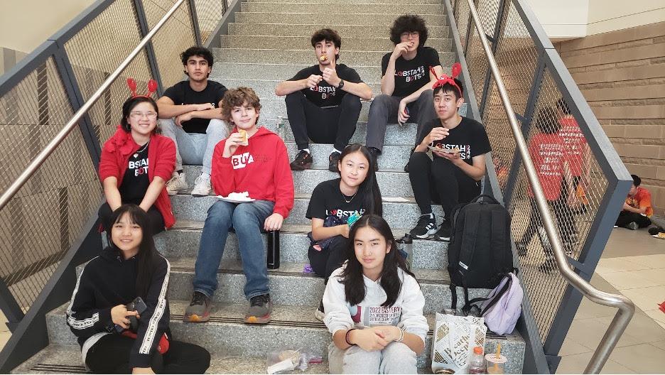 Our Lobstah Bots gathering on the staircase at N.E.R.D. during the break before playoff matches. (Dora '27, Kendree '25, Ajay '25, Nate '27, Owen '25, Sharon '27, Coco S. '27, Luke '25, Maxwell '25)