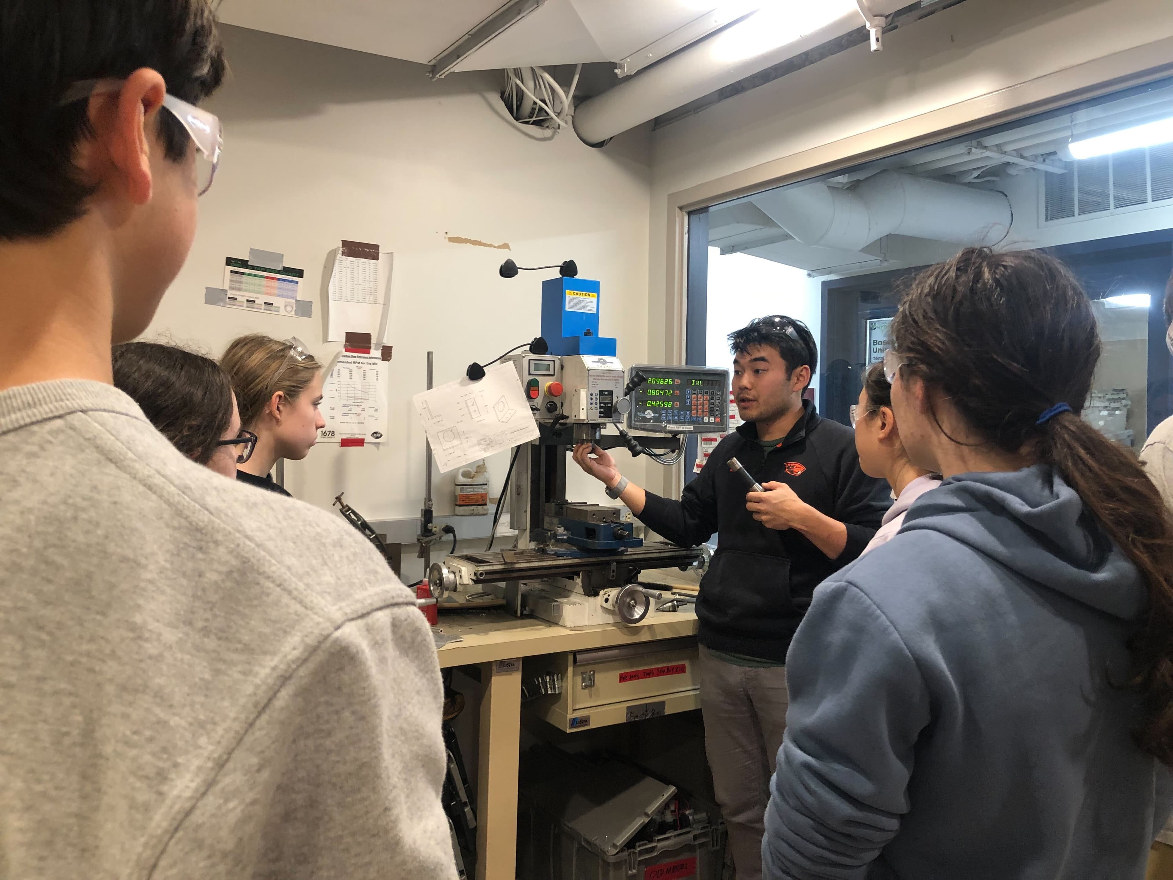 Ryo Takei (Mentor), trains students on the mill for the cart project