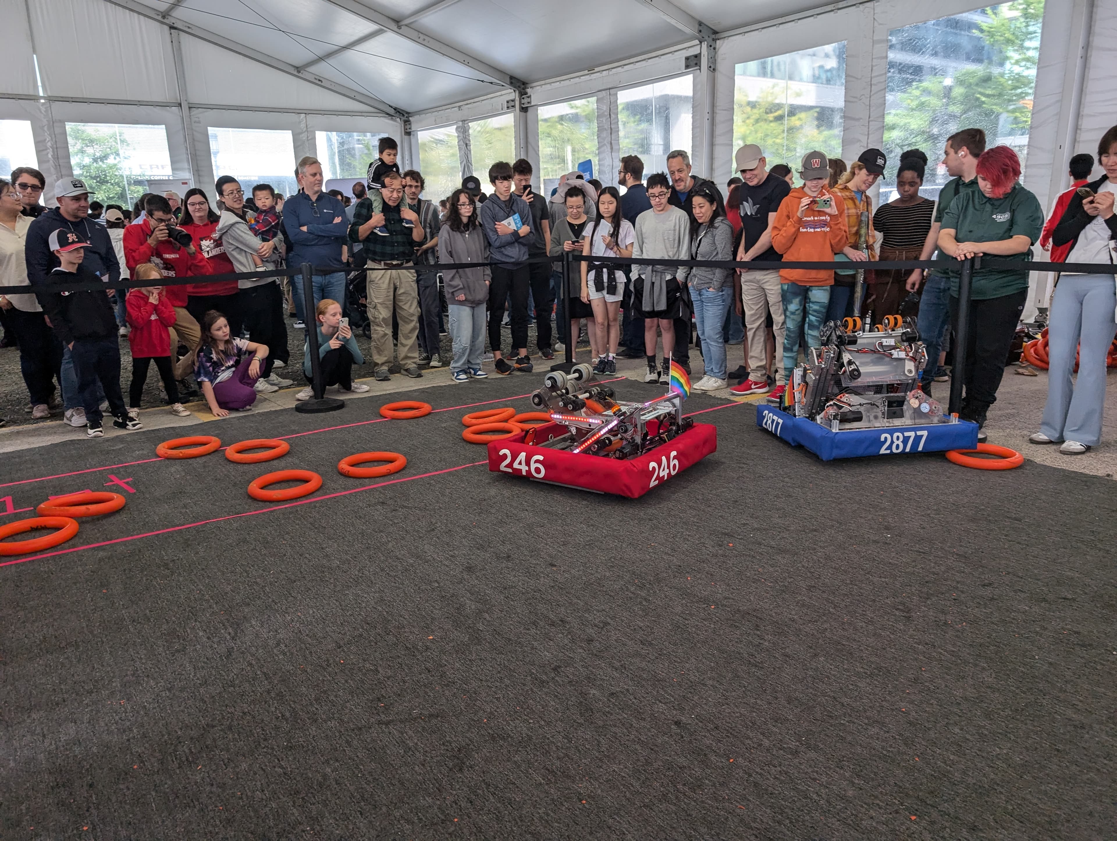 Our robot plays a game with another FRC team in front of a crowd at RoboBoston