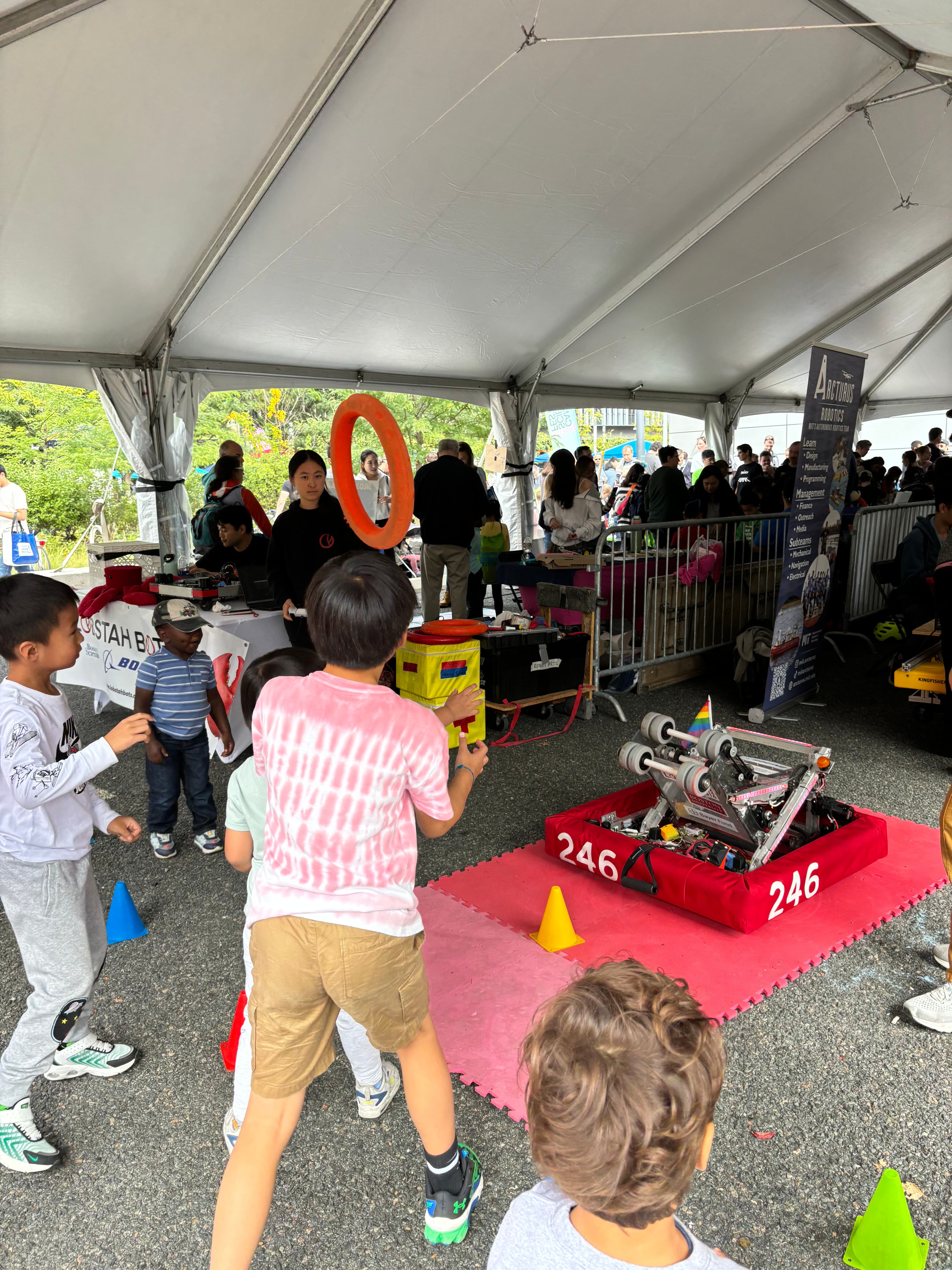 Kids play catch with our robot at the Cambridge Science Festival Carnival