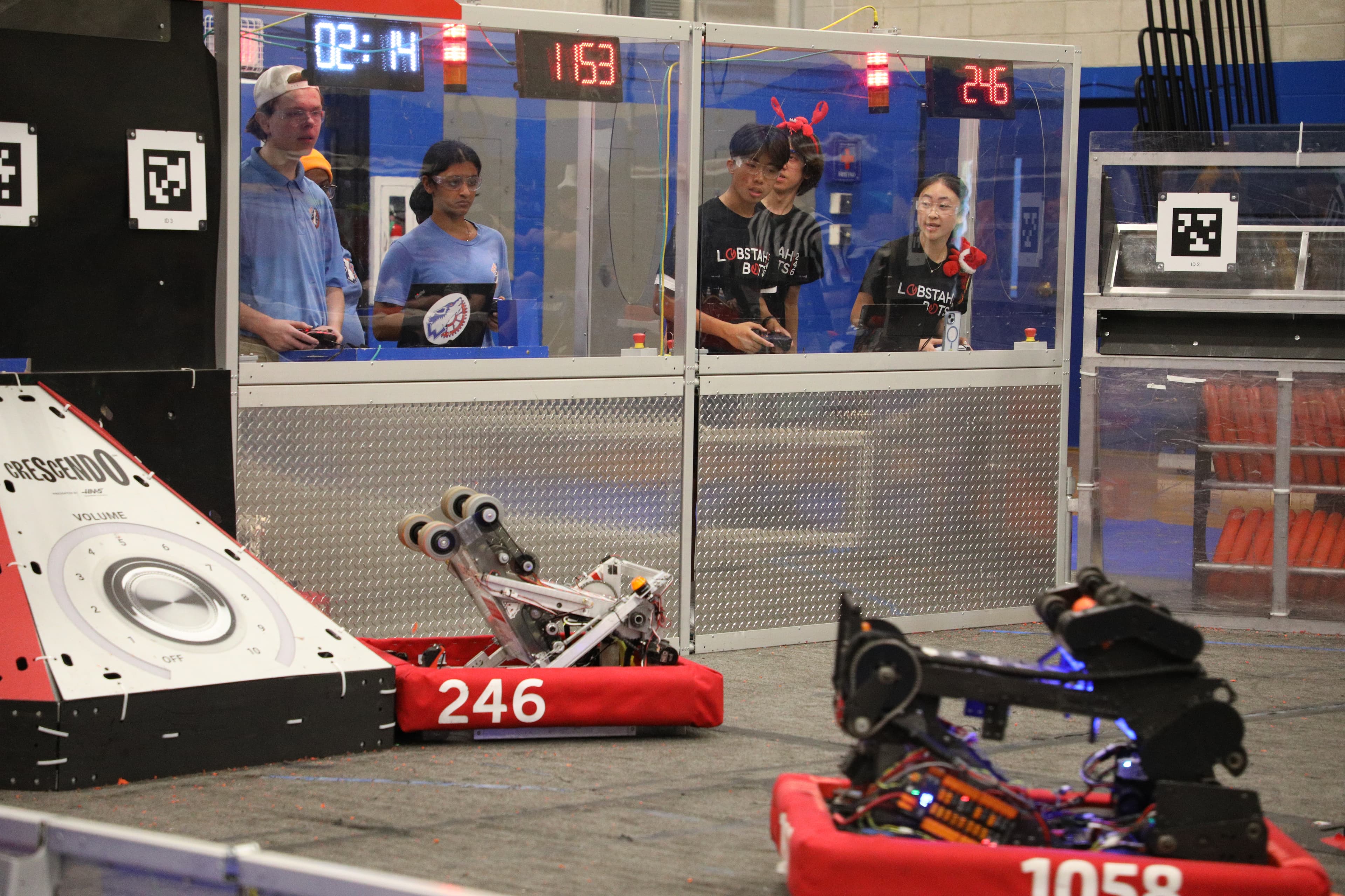 Teddy Shi ‘27, Sharon Xiong ‘27, and Maxwell Yu ‘25 line up the robot for a shot during playoffs