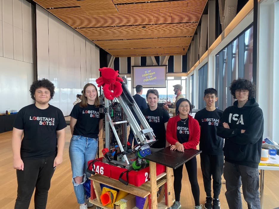 The Lobstah Bots on the 17th floor of BU’s Computing and Data Science building after the Massachusetts STEM Week Kickoff event. (Eli '24, Carolyn (Mentor), George '24, Kendree '25, Maxwell '25, Luke '25)