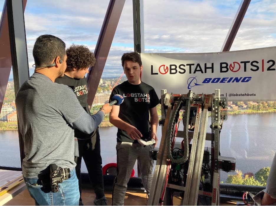 Eli '24 and George '24 being interviewed by WBZ radio about our robot at the Massachusetts STEM Week Kickoff.