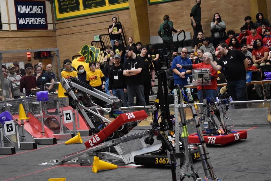 Our drive team on the left in shock as our robot nearly tips off of the charge station. Thankfully it didn’t!